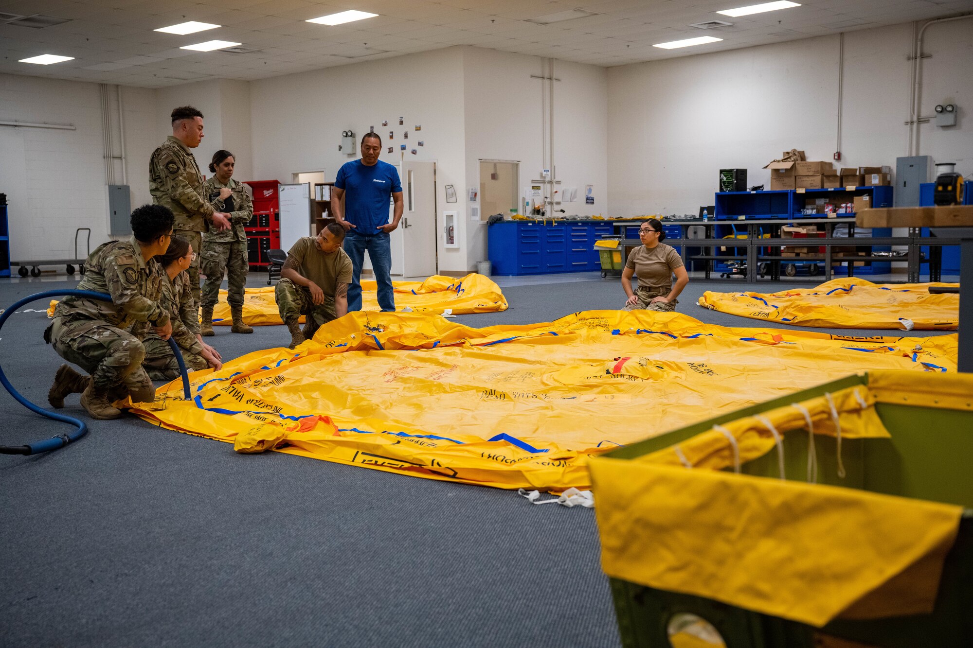 Airmen from 15th Operations Support Squadron aircrew flight equipment shop perform survival equipment functional checks on a 46-man life raft at Joint Base Pearl Harbor-Hickam, Hawaii, Jan. 11, 2023. AFE technicians are responsible for all emergency floatation devices and parachutes on Hickam aircraft. (U.S. Air Force photo by Senior Airman Makensie Cooper)