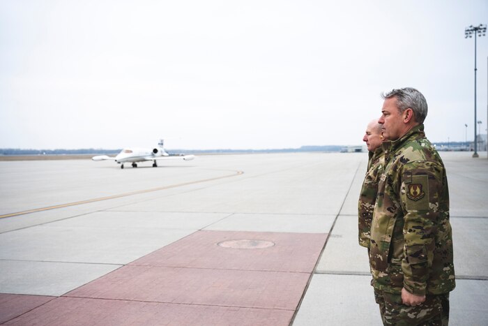 Col. Christopher Meeker (front), 88th Air Base Wing commander, and Lt. Gen. Carl Schaefer, Air Force Materiel Command deputy commander, stand at attention Jan. 9 as the jet carrying Gina Ortiz Jones, undersecretary of the Air Force, arrives at Wright-Patterson Air Force Base, Ohio.