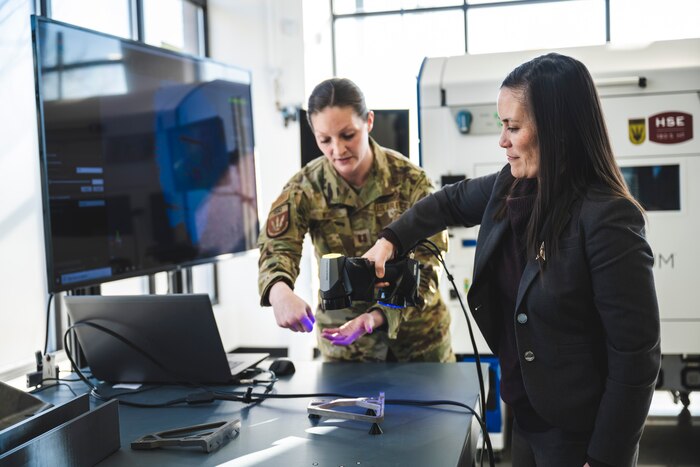 Capt. Kristina Wood, Rapid Sustainment Office program manager, shows Undersecretary of the Air Force Gina Ortiz Jones how materials are scanned Jan. 9 at The Greene in Beavercreek, Ohio.