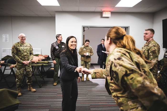 Col. Christopher Meeker (front), 88th Air Base Wing commander, and Lt. Gen. Carl Schaefer, Air Force Materiel Command deputy commander, stand at attention Jan. 9 as the jet carrying Gina Ortiz Jones, undersecretary of the Air Force, arrives at Wright-Patterson Air Force Base, Ohio.