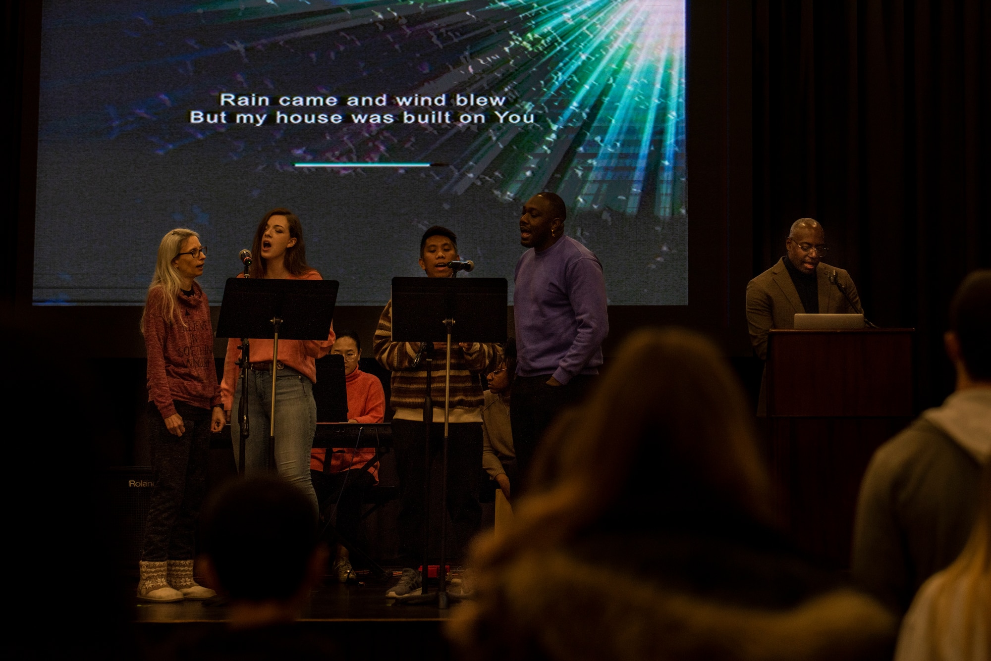 U.S. Air Force Capt. Tarvick Linder, 51st Fighter Wing chaplain, and the praise team lead the congregation in song during Protestant church service at Osan Air Base, Republic of Korea, Jan. 15, 2023.