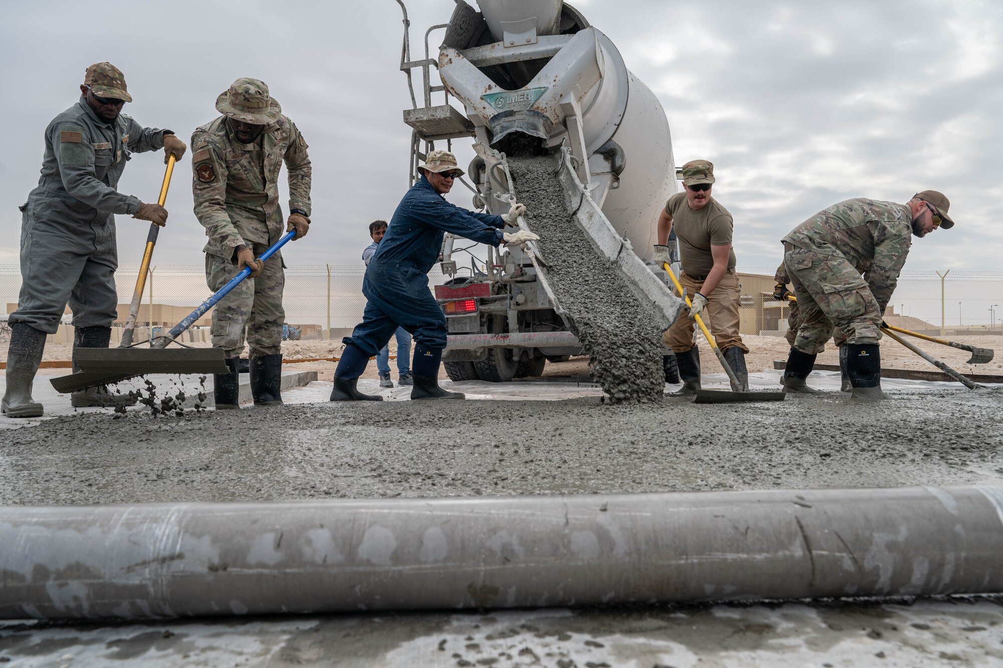 A photo of Airmen pouring concrete.