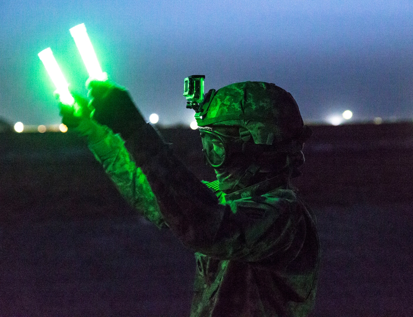 Sgt. 1st Class Joann Duclose, a senior human resources sergeant from the 642nd Aviation Support Battalion, flags in a UH-60 Black Hawk during night sling-load training with aviators from 3rd Battalion, 142nd Assault Helicopter Battalion, June 5, 2014, in Camp Buehring, Kuwait, during the battalion's 2014 deployment. Soldiers of the 642nd Aviation Support Battalion will deploy to the Middle East again in 2023.