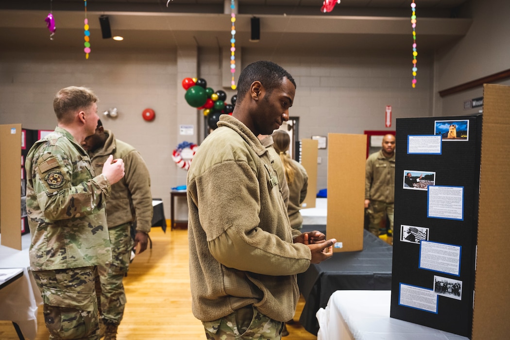 Airman looks at at info poster during MLK Day observance at the USO.