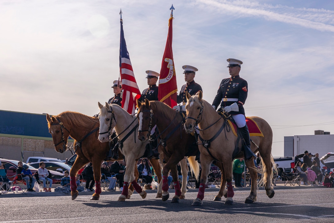 U.S. Marines with the Marine Corps Mounted Color Guard, Marine Corps Logistics Base Barstow, march in the 2022 Victorville Children Christmas Parade in Victorville, California, Dec. 3, 2022. The Marine Corps Mounted Color Guard travels around the continental United States performing various events such as parades, ceremonies and rodeos.