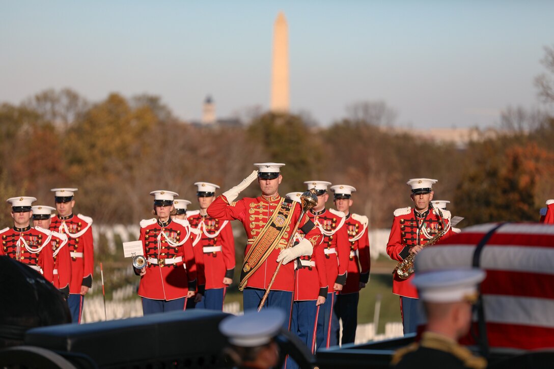 The Drum Major of the Marine Band salutes at the funeral ceremony for former Marine Band Oboist Jim Dickey in Arlington National Cemetery.

On Nov. 22, 2022, the United States Marine Band said a final farewell to one of its own in a funeral ceremony at Arlington National Cemetery. Oboist James "Jim" Dickey served in "The President's Own" from 1977 to 2005. He was a frequently featured soloist and served as a tour coordinator with the band. In addition to band support of the funeral, many band members and friends came out in honor of Jim and in support of his family.
.
(U.S. Marine Corps photos by Staff Sgt. Chase Baran/ Released)