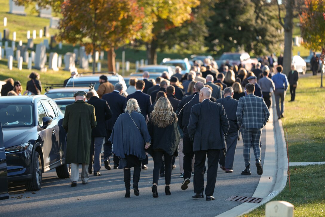 Friends and family return to their vehicles in Arlington National Cemetery at the funeral ceremony for former Marine Band Oboist Jim Dickey.

On Nov. 22, 2022, the United States Marine Band said a final farewell to one of its own in a funeral ceremony at Arlington National Cemetery. Oboist James "Jim" Dickey served in "The President's Own" from 1977 to 2005. He was a frequently featured soloist and served as a tour coordinator with the band. In addition to band support of the funeral, many band members and friends came out in honor of Jim and in support of his family.
.
(U.S. Marine Corps photos by Staff Sgt. Chase Baran/ Released)