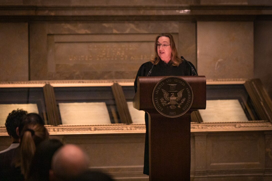 The Honorable Beryl A. Howell makes opening remarks for a naturalization ceremony while standing in front of the U.S. Constitution at the National Archives on Dec. 15, 2022.

(U.S. Marine Corps Photos by Staff Sgt. Chase Baran/released)