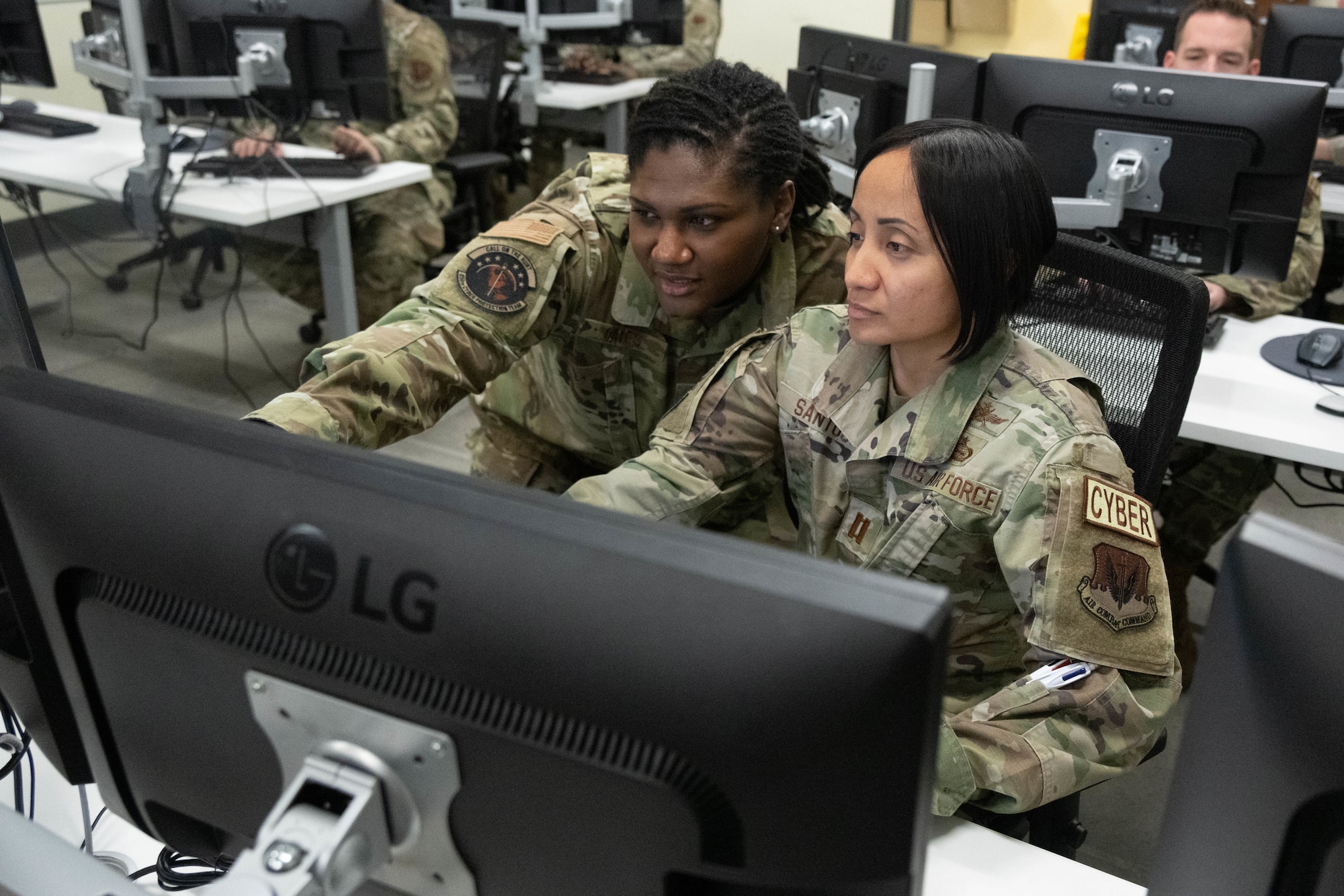 Airmen assigned to the 275th Cyberspace Operations Squadron work at a computer terminal at Warfield Air National Guard Base at Martin State Airport, Middle River, Md., on January 10, 2023.