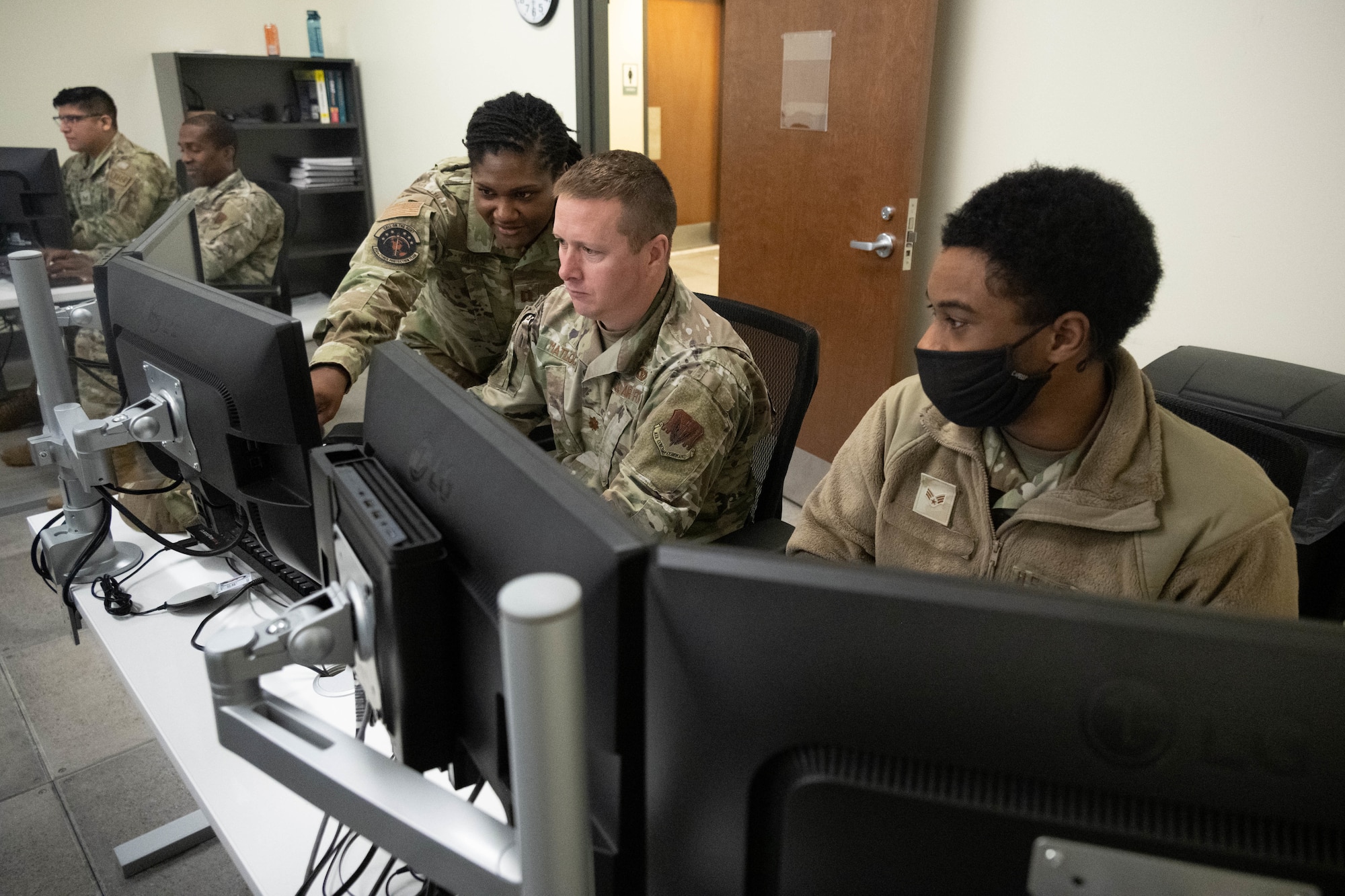 Airmen assigned to the 275th Cyberspace Operations Squadron work at a computer terminal at Warfield Air National Guard Base at Martin State Airport, Middle River, Md., on January 10, 2023.