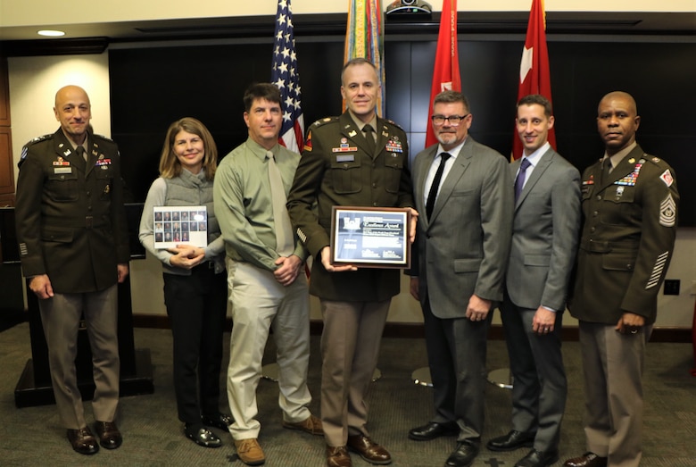 group of seven people receive an award