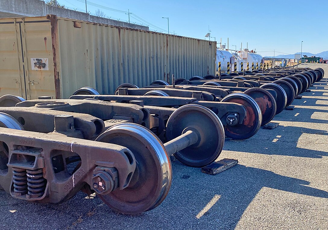 Large rail wheels sit in a row.