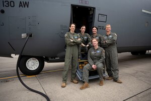 Airmen from the 130th Airlift Wing pose for a photo at McLaughlin Air National Guard Base, Charleston, W.Va., January 20, 2023. Before the first all-female crew in the unit's history took off en route to Naval Air Station Key West's Boca Chica Field in Key West, Florida, for an aeromedical evacuation training mission. (U.S. Air National Guard photo by Senior Master Sgt. Eugene Crist)