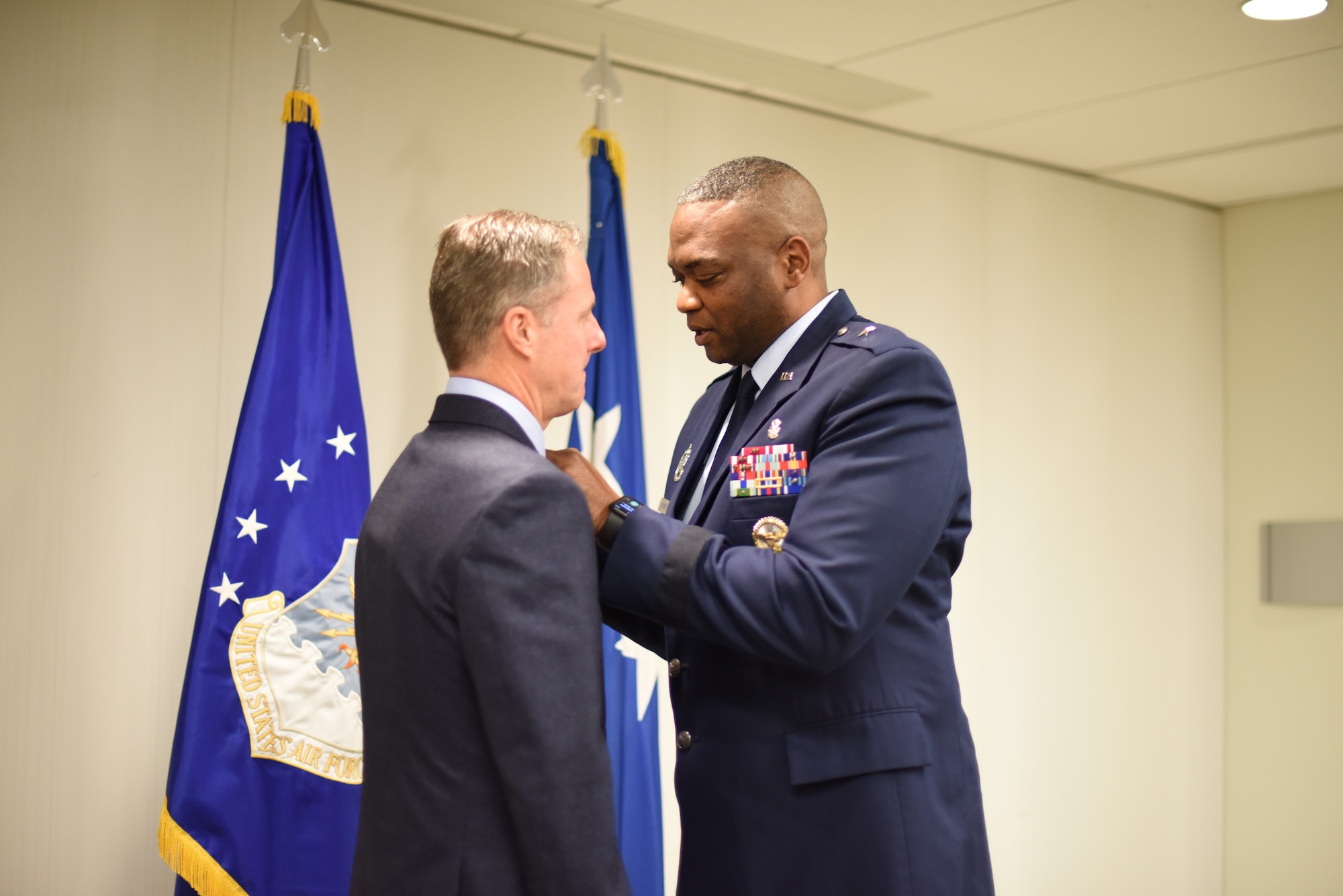 Image of an Airman honoring a civilian.