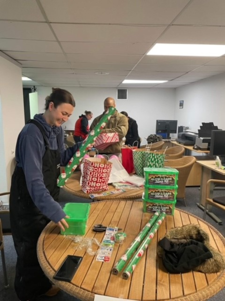 Volunteers for Operation Julemand, a Greenlandic holiday, wrap presents to give to the local villages at Thule Air Base, Greenland in November 2022.