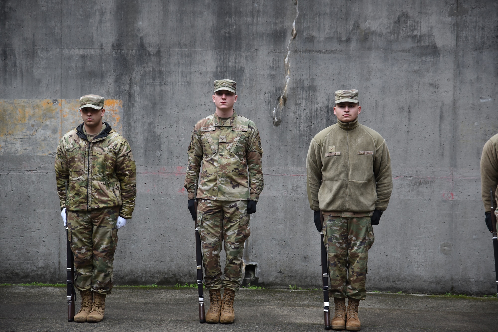 U.S. Airmen from multiple base Honor Guards stand at attention during colors training at Joint Base Lewis-McChord, Washington, Jan. 19, 2023. Honor Guardsmen from Beale Air Force Base, California, Minot Air Force Base, North Dakota, and Fairchild Air Force Base, Washington, traveled to JBLM to train with the U.S. Air Force Honor Guard mobile training team from Joint Base Anacostia-Boiling, Washington D.C.