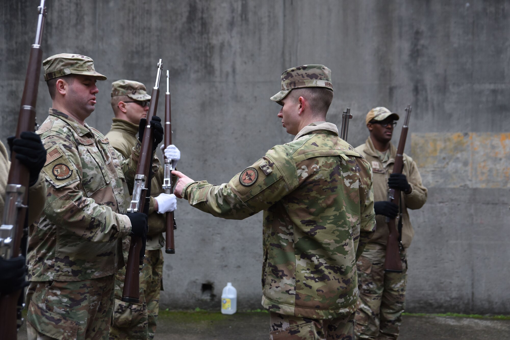 U.S. Air Force Staff Sgt. Jeffery Herron, non-commissioned officer in charge of formal training with the U.S. Air Force Honor Guard mobile training team, instructs Airmen on proper handling of their training weapon during colors training at Joint Base Lewis-McChord, Washington, Jan. 19, 2023. Herron and three other training instructors traveled to JBLM Joint Base Anacostia-Bolling, Washington D.C¸ to train Honor Guardsmen to standardize all base Honor Guard programs.
