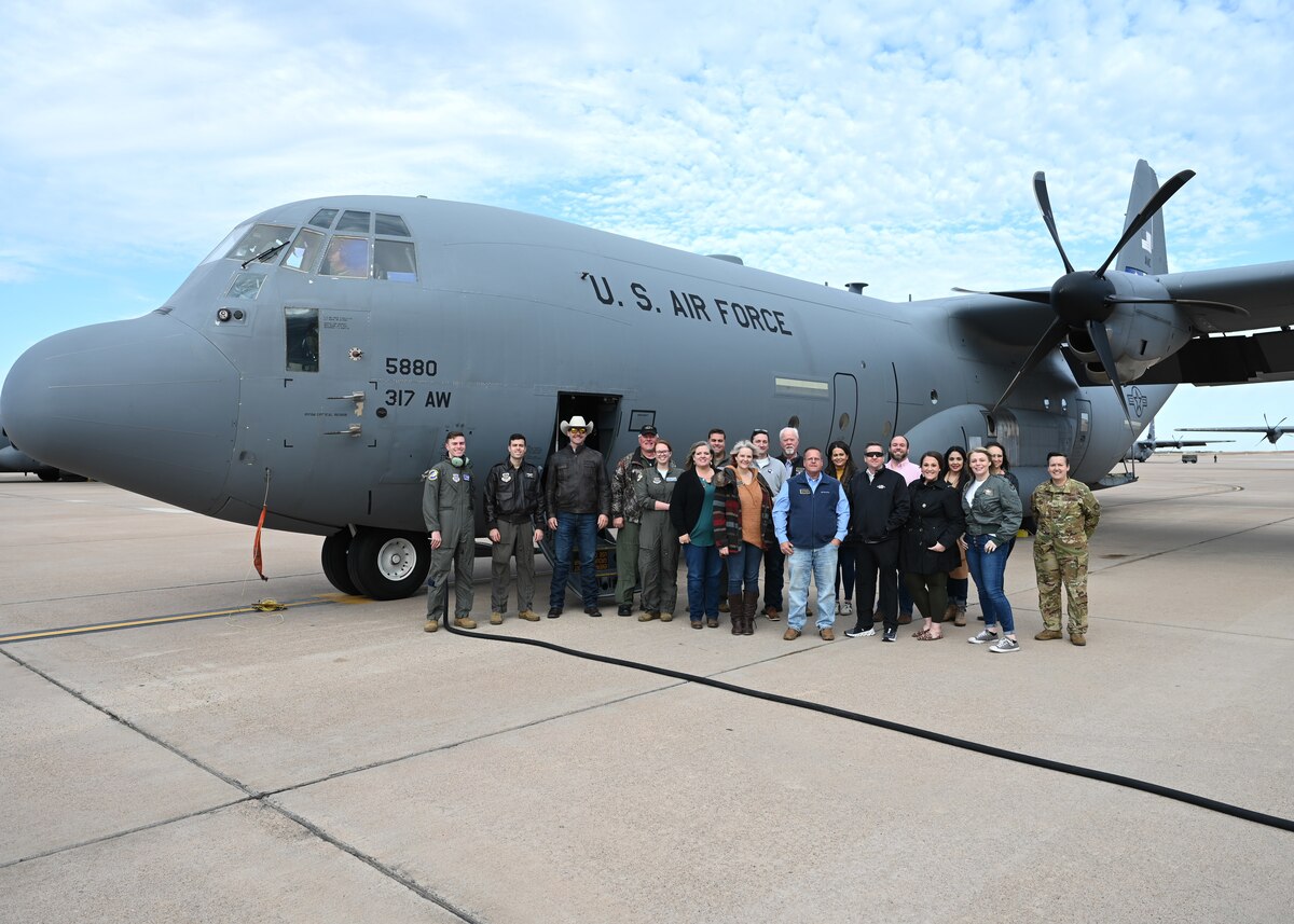 The 17th Training Wing Honorary Commanders pose for a photo in front of a C-130J Super Hercules, Dyess Air Force Base, Texas, Jan. 20, 2023. Honorary commanders visited Dyess to experience the missions of the 7th Bomb Wing and 317th Airlift Wing. (U.S. Air Force photo by Airman 1st Class Zachary Heimbuch)