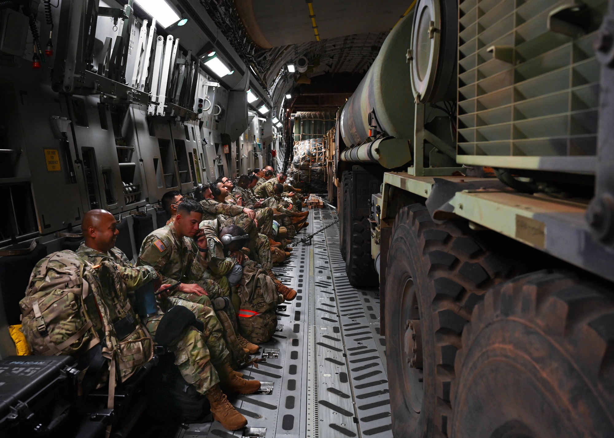 Members of the 593d Expeditionary Sustainment Command, 25th Division Sustainment Brigade, 25th Infantry Division, rest on a C-17 Globemaster III while flying to the Island of Hawaii to participate in Operation PIKO, Jan. 10, 2022. Operation PIKO is a series of tactical exercises which simultaneously maintain Soldier’s weapons proficiency and strengthen air, land and sea deployment capabilities within the Indo-Pacific. (U.S. Air Force photo by Senior Airman Zoie Cox)