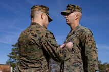 U.S. Marine Corps Lt. Col. Robert D. Barbaree III, left, commanding officer of Headquarters and Headquarters Squadron (H&HS), Marine Corps Air Station (MCAS) New River, pins the Bronze Star Medal onto Master Sgt. Kevin Haunschild, right, a senior air traffic controller with H&HS, MCAS New River, on MCAS New River in Jacksonville, North Carolina, Jan. 20, 2023. Haunschild received the Bronze Star medal for his actions as Marine Air Traffic Control Mobile Team Leader with Marine Medium Tiltrotor Squadron-162 during Operation Freedom’s Sentinel. (U.S. Marine Corps photo by Cpl. Antonino Mazzamuto)