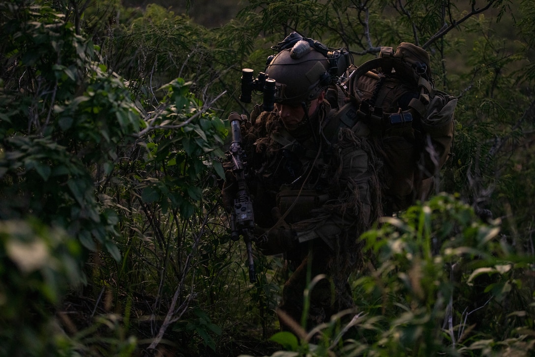 U.S. Marine Corps Cpl. James Cerny, with Amphibious Reconnaissance Platoon, sniper team, 31st Marine Expeditionary Unit, hikes to his live fire exercise position, part of Realistic Urban Training Exercise 23.1 Marine Corps Base Hawaii Crater, Jan. 11, 2023. The purpose of RUTEX is to incorporate the specialized individual and small unit skills of the MEU and conduct high-intensity, advanced, and complex Marine Air Ground Task Force operations in order to prepare MEUs and other designated forces to support the geographic combatant commanders. (U.S. Marine Corps photo by Lance Cpl. Clayton Baker)