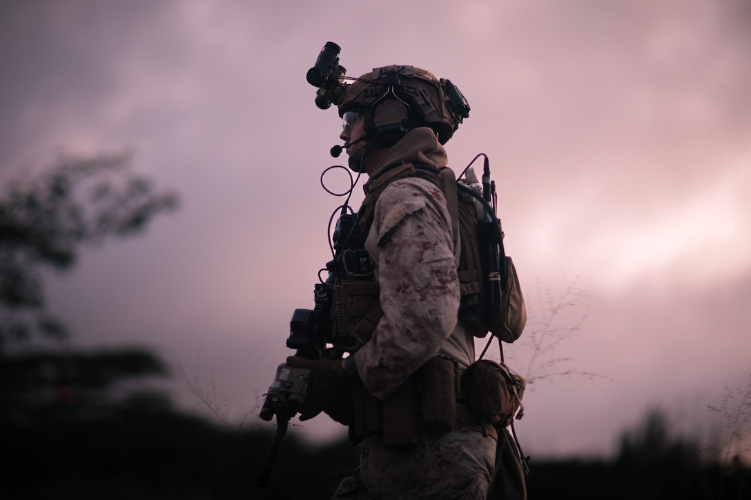 A U.S. Marine with the 31st Marine Expeditionary Unit’s Maritime Raid Force, patrols through a field during a simulated limited scale raid, part of a Realistic Urban Training Exercise, Kahuku Training Area, Hawaii, Jan. 15, 2023. The purpose of the RUTEX is to incorporate the specialized individual and small-unit skills of the MEU and conduct high-intensity, advanced and complex Marine Air Ground Task Force operations in order to prepare MEUs and other designated forces to support the geographic combatant commanders. (U.S. Marine Corps photo by Cpl. Christian Tofteroo)