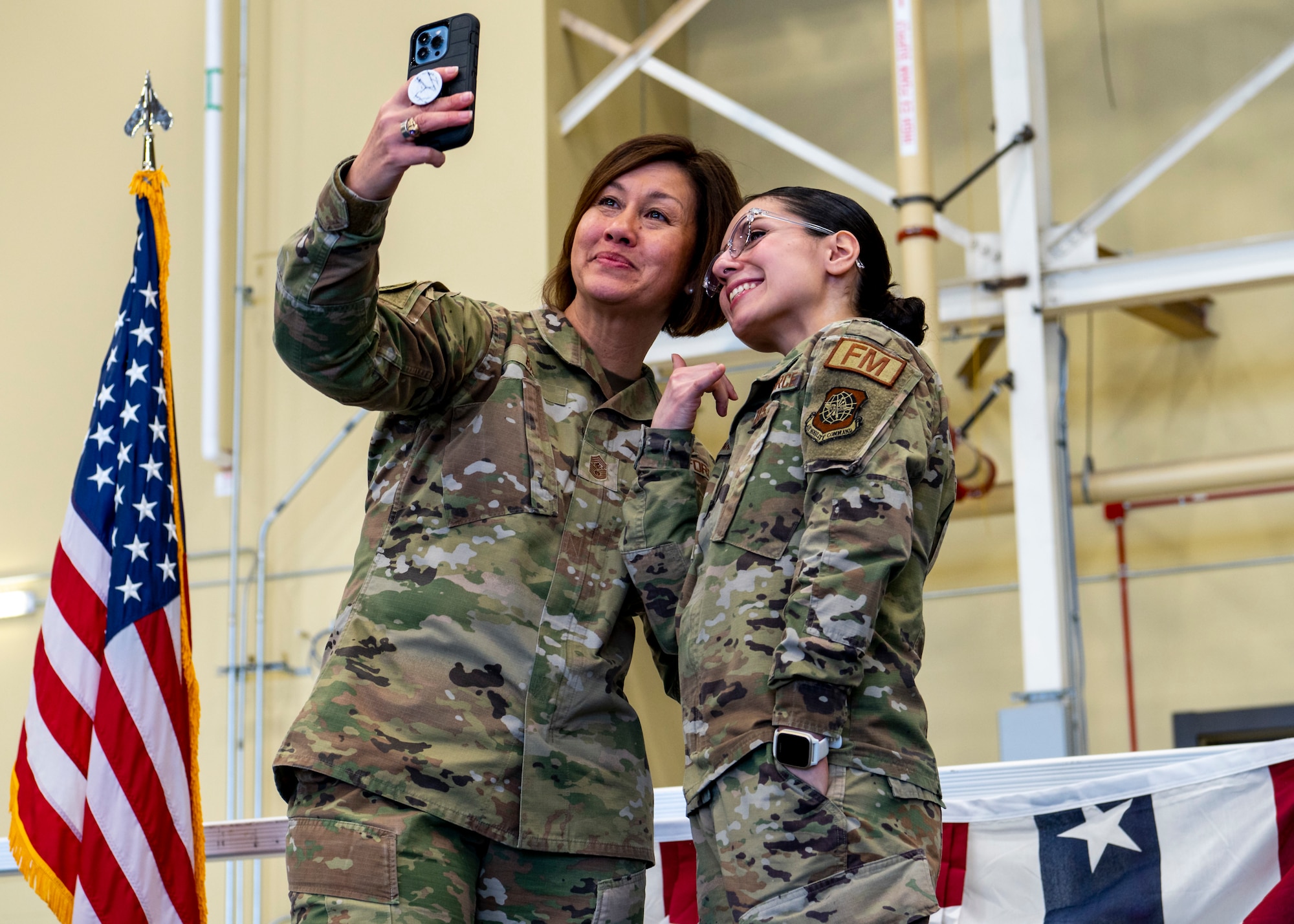 Chief Master Sergeant of the Air Force JoAnne S. Bass takes a selfie with a Fairchild Airman during her visit at Fairchild Air Force Base, Washington, Jan. 19, 2023. Chief Bass spoke to Fairchild AFB personnel about her priority of focusing on the needs of Airmen and accelerating change to stay ahead of the United States’ adversaries. (U.S. Air Force photo by Airman 1st Class Stassney Davis)