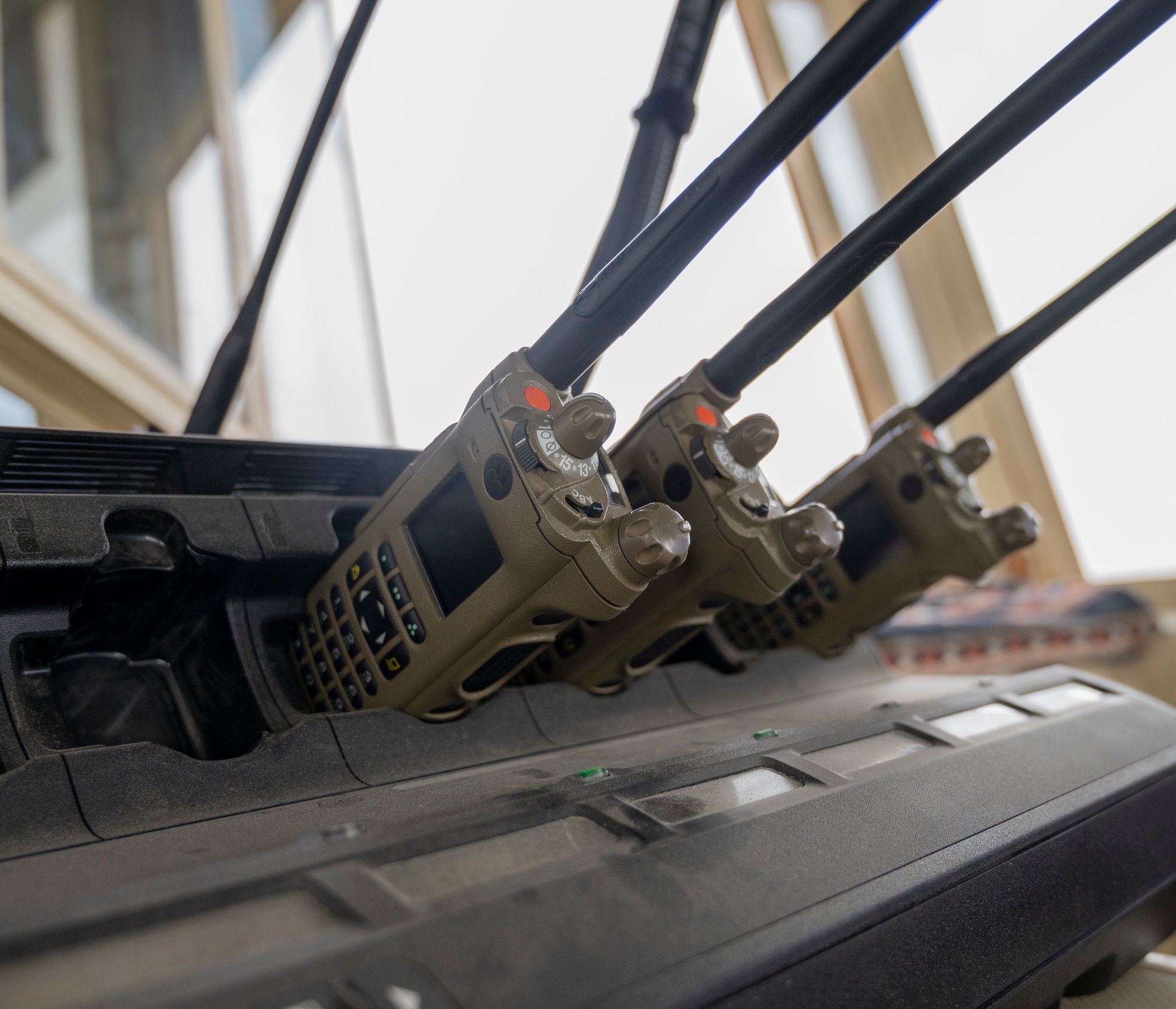 Radios charge in their charging cradle at the Ali Al Salem Air Traffic Control Tower on Jan. 16, 2023.