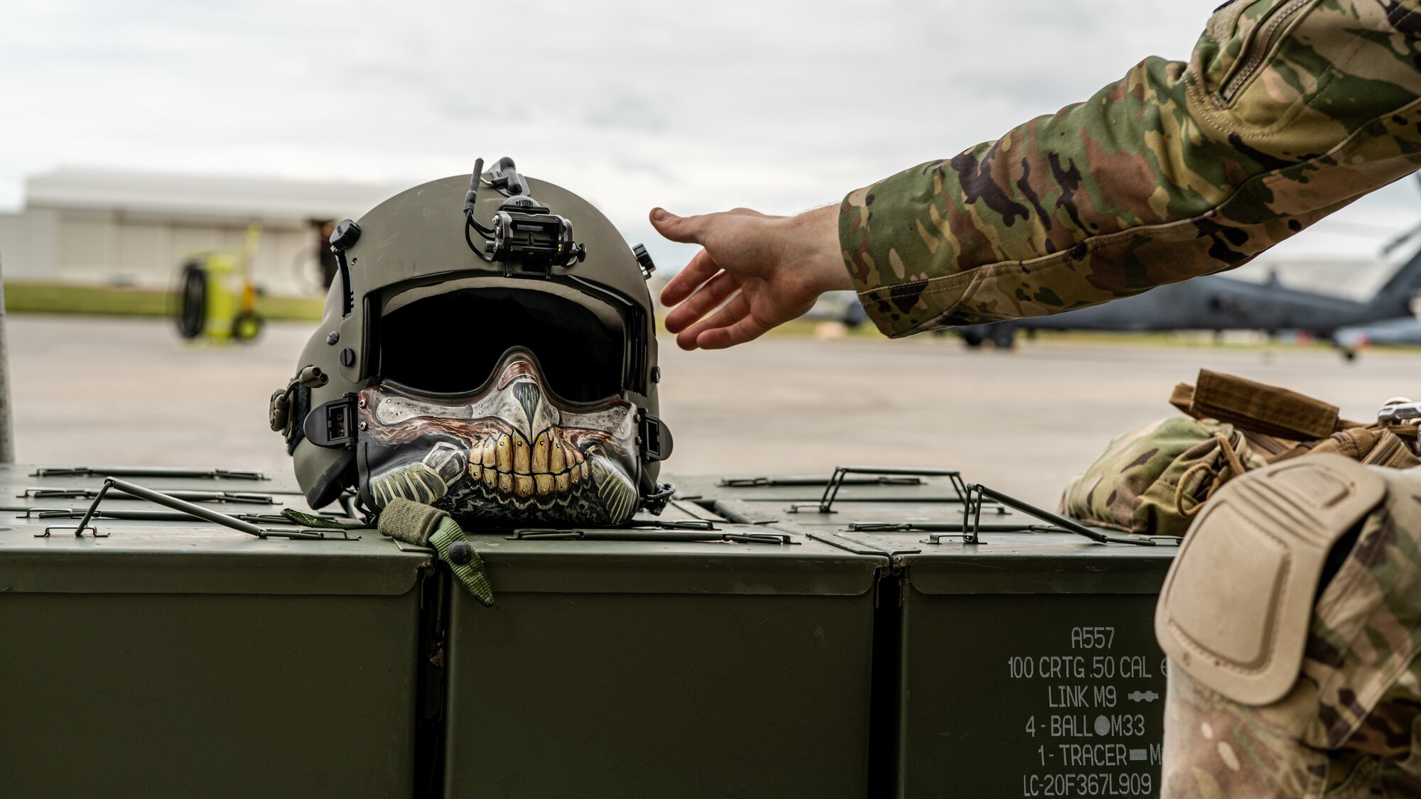 An Airman grabs their helmet.