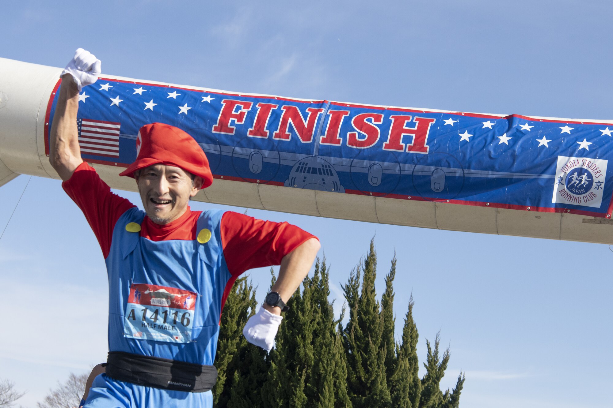 Taizo Asao, a half-marathon race participant, leaps in the air after finishing a half-marathon during the 42nd annual Frostbite Road Race.