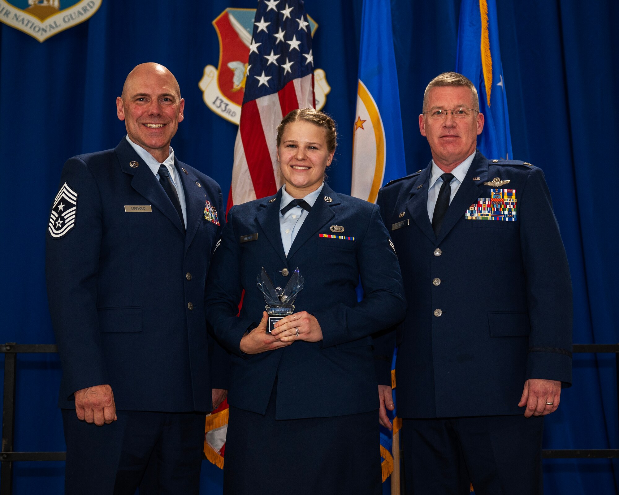 U.S. Air Force Airman 1st Class Mindy Pitzner, 133rd Comptroller Flight, receives the 2022 Junior Enlisted Airman of the Year award in St. Paul, Minn., Dec. 11, 2022.