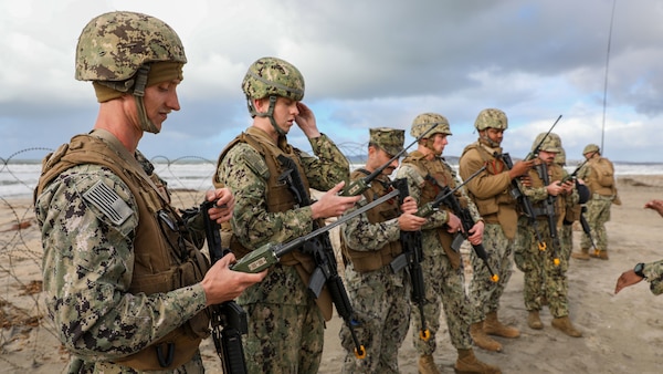 Sailors assigned to Naval Beach Group 1 conduct a radio check during an anti-terrorism training scenario in support of an amphibious landing exercise, Jan. 17, 2023.