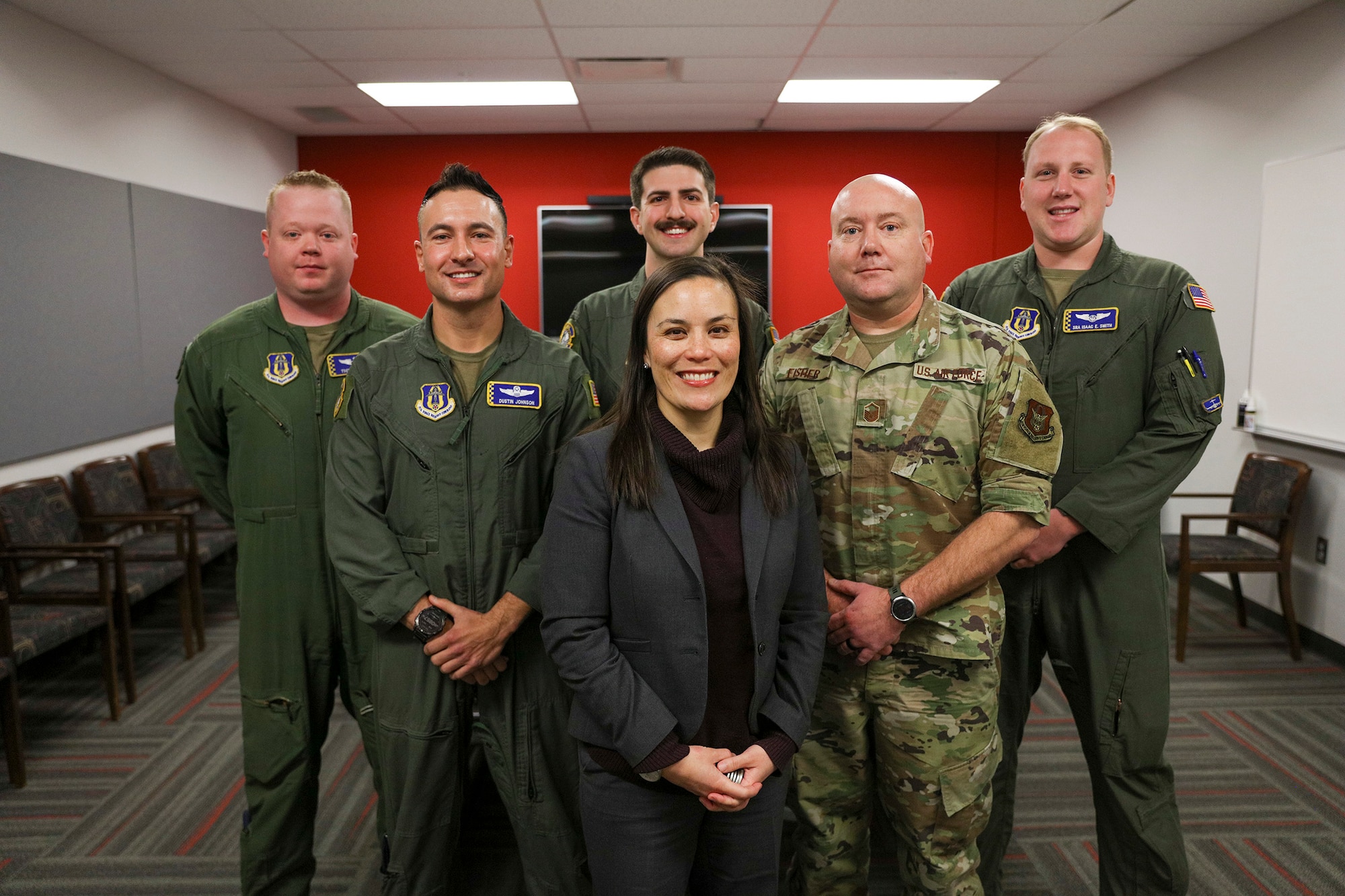 The Honorable Gina Ortiz Jones, Under Secretary of the Air Force, poses with the 445th Airlift Wing's 89th Airlift Squadron aircrew (left to right: Tech. Sgt. Zachary Webb, Lt. Col. Dustin Johnson, 1st Lt. Logan Sisca, Master Sgt. Spencer Fischer (assigned to the 445th Aircraft Maintenance Squadron) and Senior Airman Isaac Smith) Jan. 9 as part of her visit to Wright-Patterson Air Force Base, Ohio. The Airmen were part of the aircrew of Reach 828 and delivered the first Afghan baby, Reach, onboard a 445th AW C-17 Globemaster III during the evacuation in August 2021.