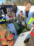 Sgt. Patrick Blaesing, a Wisconsin Army National Guard combat medic, works with local first responders to load a simulated patient for transport by Black Hawk helicopter during a search and rescue training exercise Jan. 14, 2023, in southern Lincoln County.