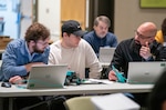 IMAGE: Integrated Combat Systems Department scientist Justin Lowell (center) mentors Westmoreland High School teacher Chastaine Perry (left) and Colonial Beach High School Supervisor of Technology Ameer Mir in preparing their schools’ robots for this year’s Innovation Challenge @ Dahlgren. The robotics competition takes place March 31-April 1 at the University of Mary Washington Dahlgren Campus.