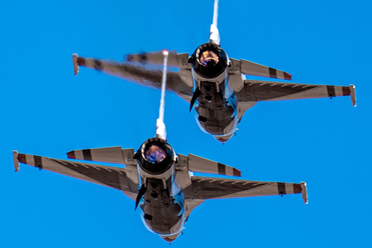 Two aircraft fly in formation.