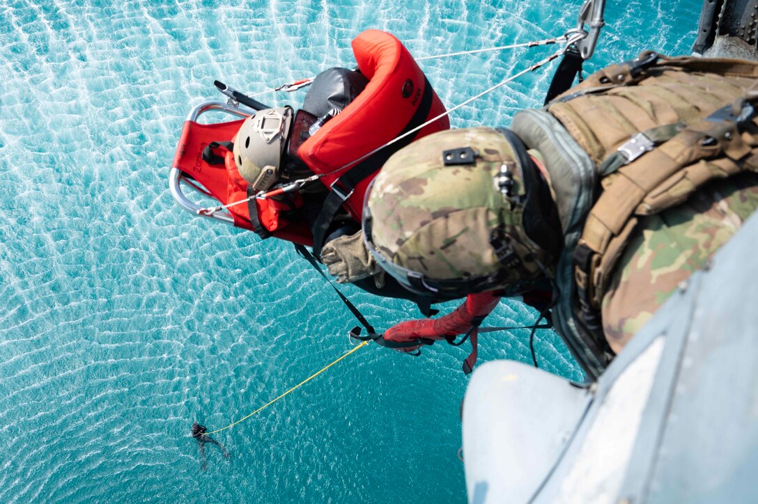 ARABIAN GULF (Jan. 22, 2023) Naval Air Crewman (Helicopter) 2nd Class Cameron Wheeler, left, and Naval Air Crewman (Helicopter) 1st Class Aaron Stagg, both assigned to Helicopter Sea Combat Squadron (HSC) 26, hoist a simulated casualty during exercise Neon Defender 23 in the Arabian Gulf, Jan. 22, 2023. Neon Defender is an annual bilateral training event between U.S. Naval Forces Central Command and Bahrain that focuses on maritime security operations, installation defense and medical response. (U.S. Navy photo by Mass Communication Specialist 2nd Class Jacob Vernier)