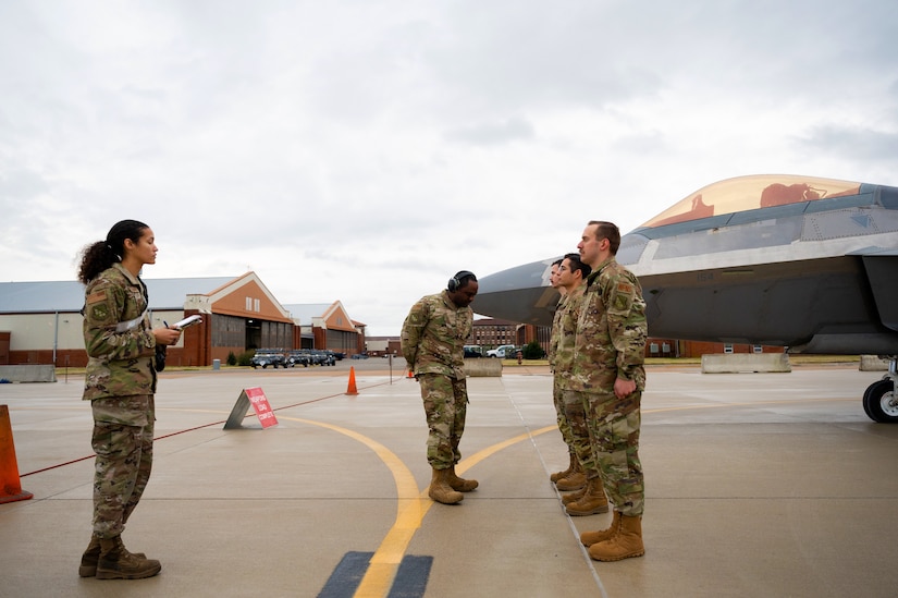 Airmen stand in line for uniform inspections.