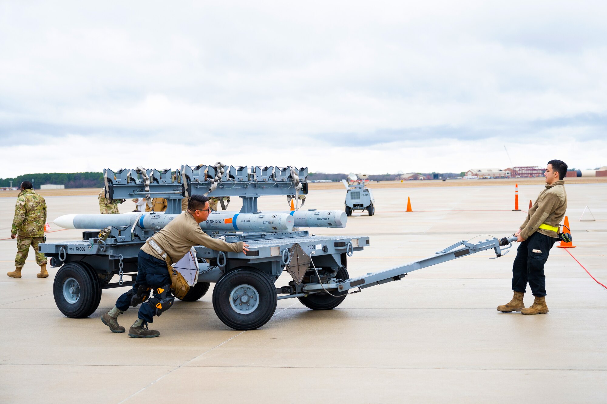 Airmen transport missile rack to loading station.