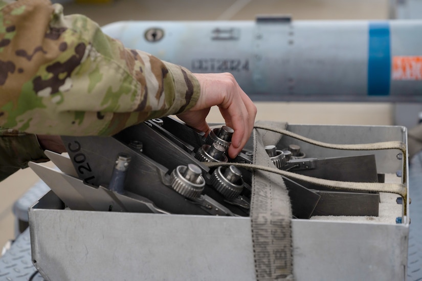Airman inspects missile fins.