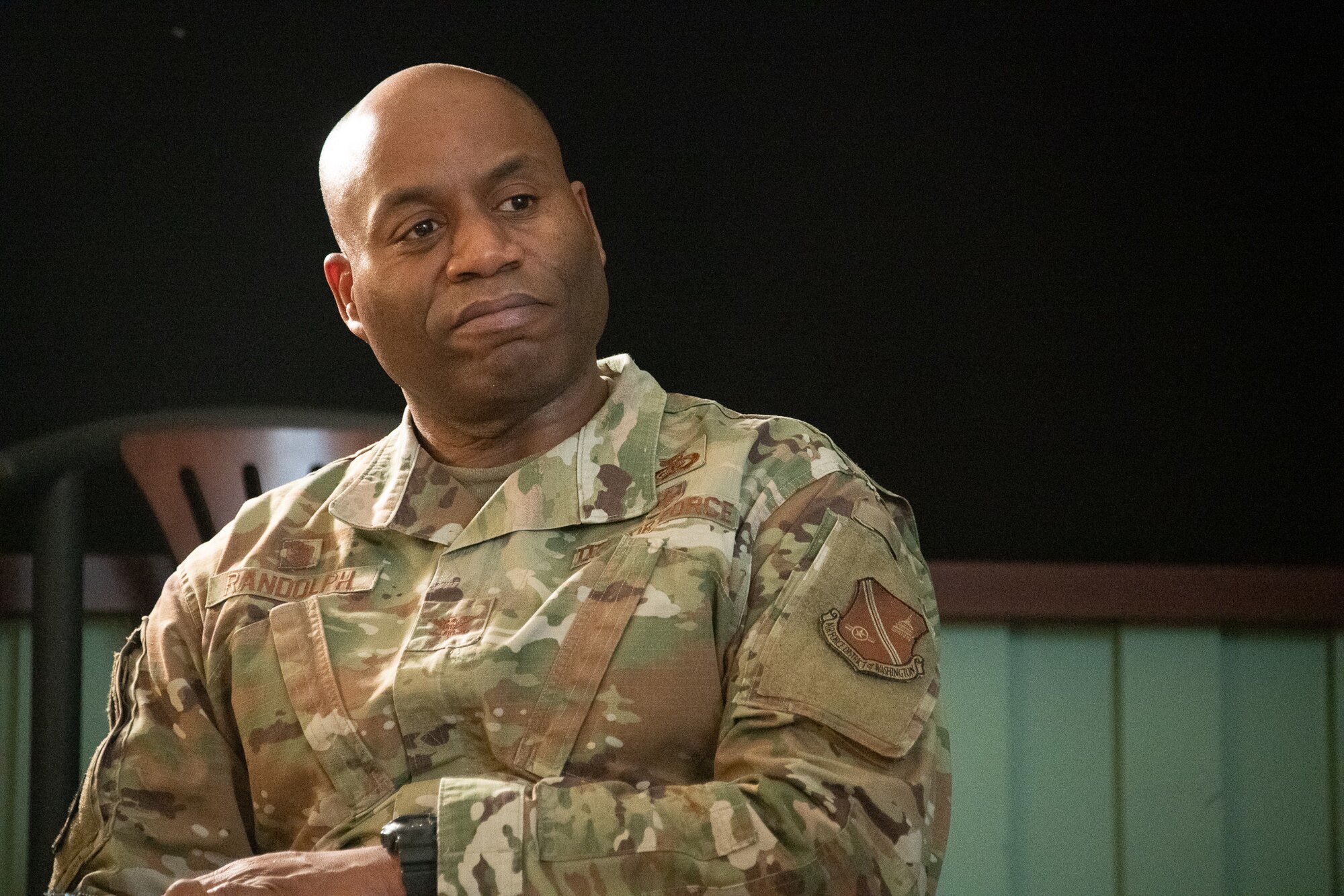 A man in an Air Force uniform sits.