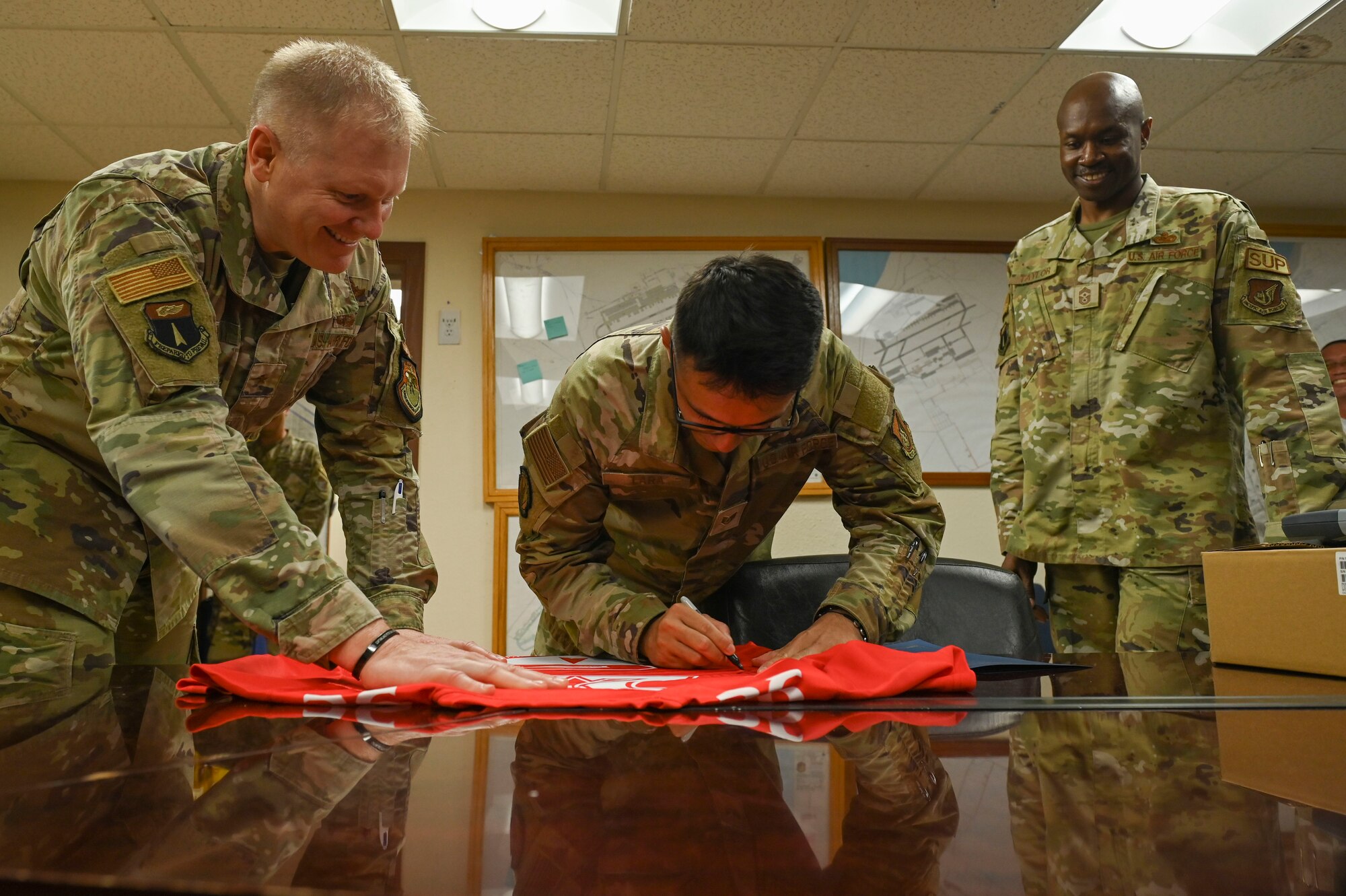 A person signs a jersey.