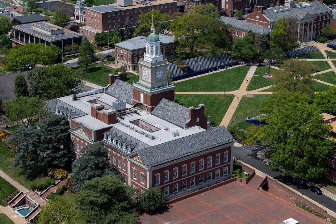 A stately building sits amidst green space.