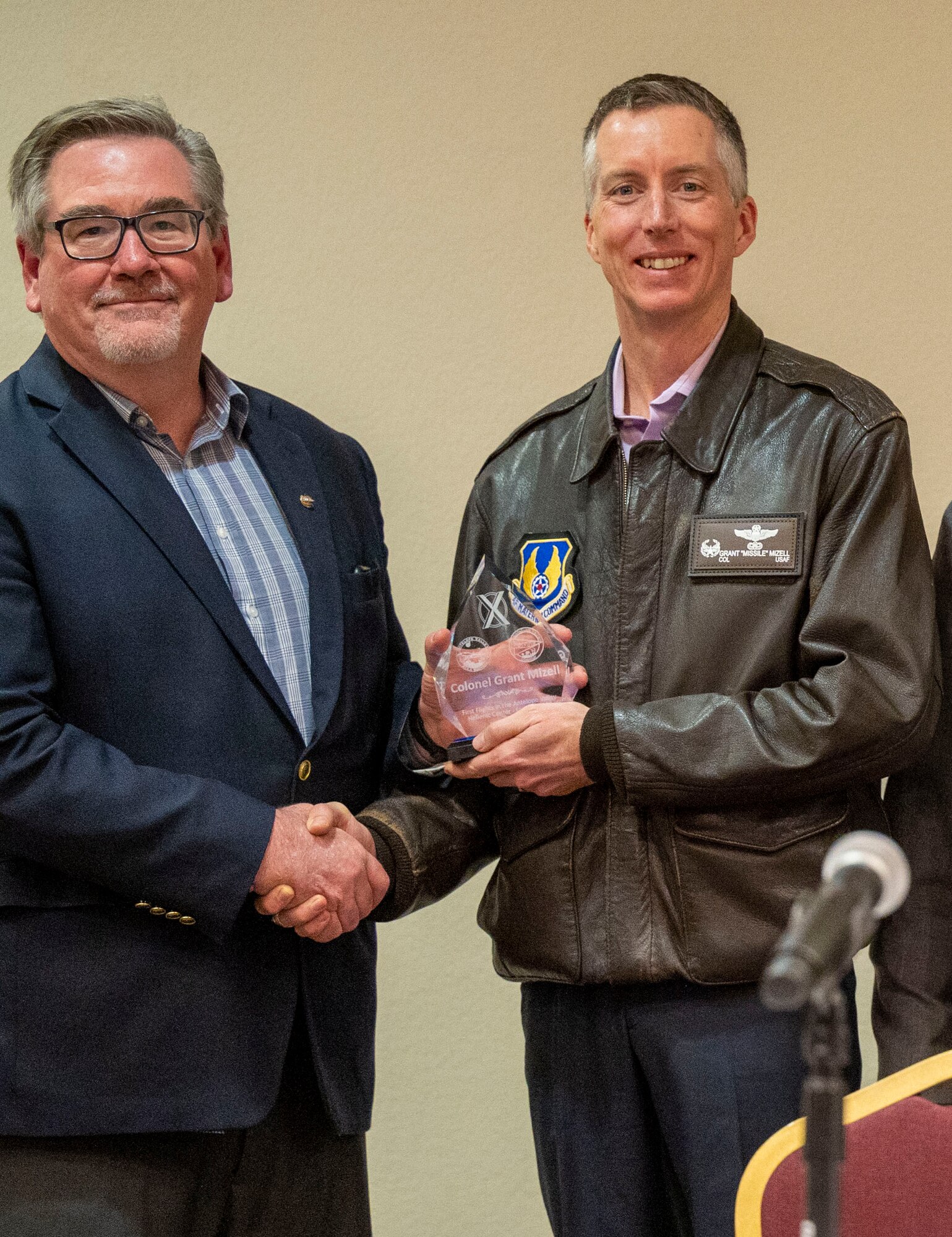 Col. Grant Mizell, Commander, 412th Operations Group receives an award from Mr. James Sergeant, Society of Flight Test Engineers, for moderating the First Flight Consideration Panel.