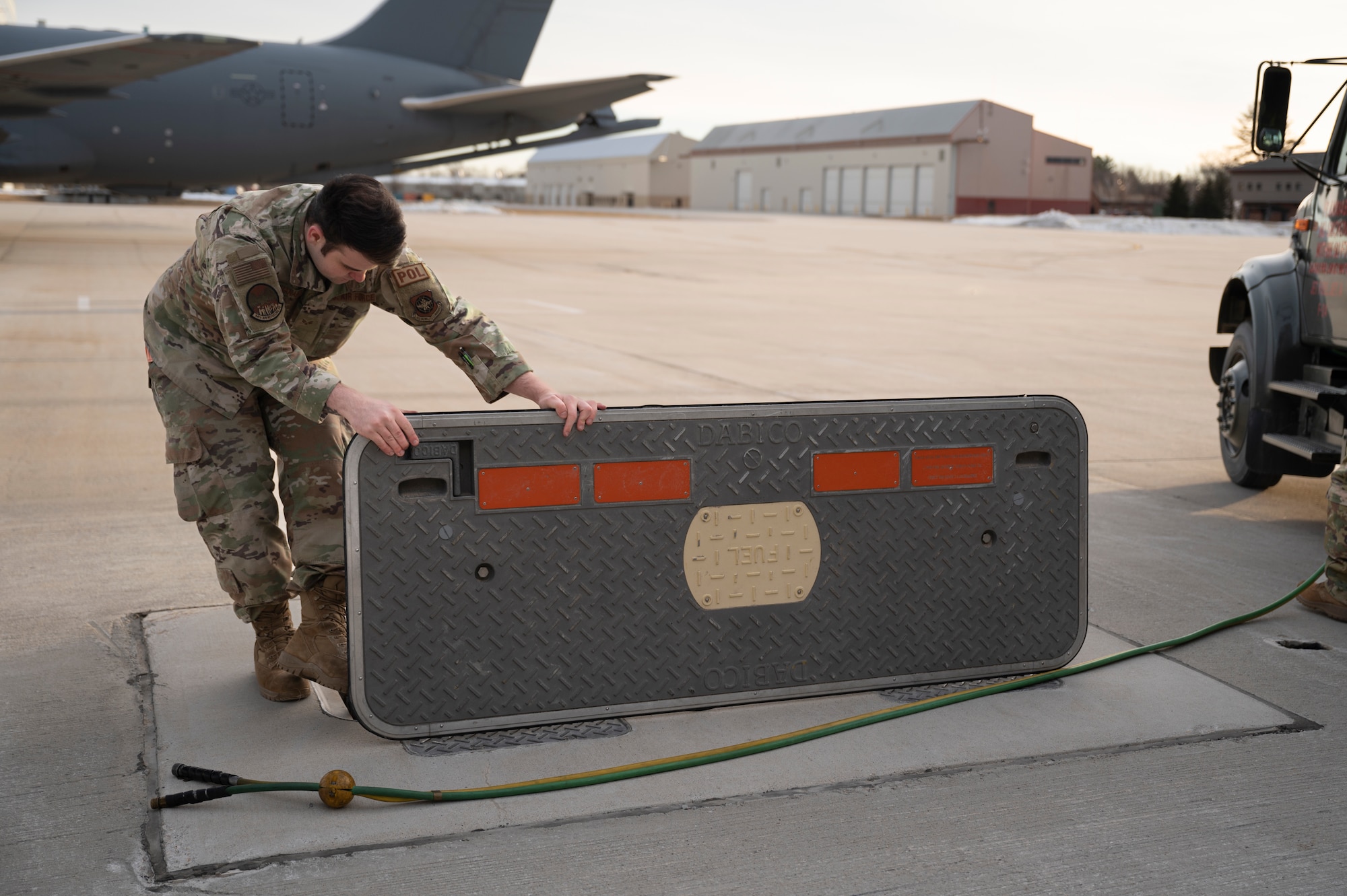 Senior Airman Spenser McManamy, a member of the petroleum, oils and lubricants flight with the 64th Air Refueling Squadron, finishes refueling a KC-46 Pegasus Jan. 19, 2023 at Pease Air National Guard Base, New Hampshire. The mission was the first flight fully generated by all 64th ARS air and ground crews. (U.S. Air National Guard photo by Staff Sgt. Victoria Nelson)