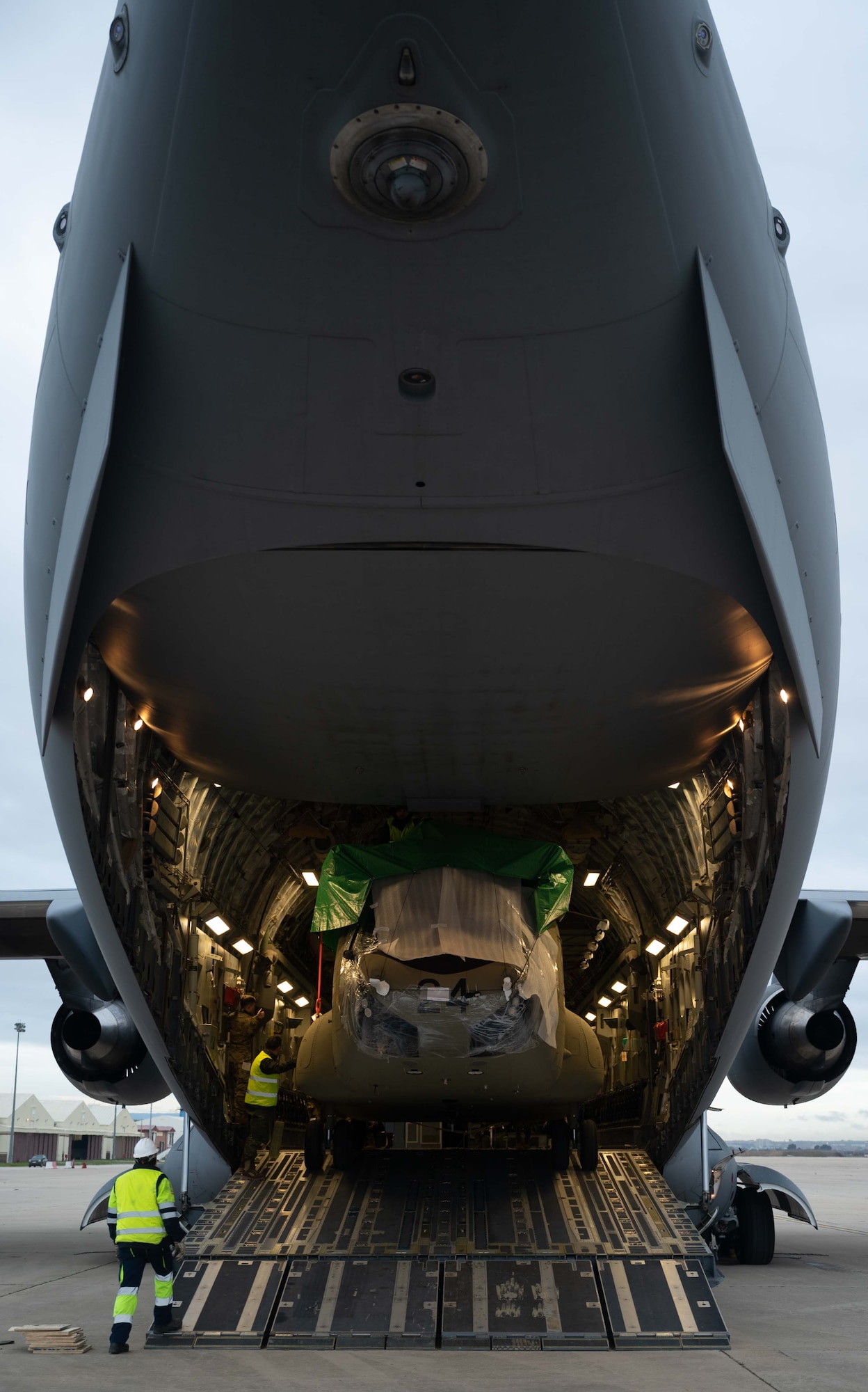 A CH-47F Chinook helicopter is unloaded from a C-17 Globemaster III assigned to Dover Air Force Base, Delaware, during a foreign military sales mission at Torrejón Air Base, Spain, Jan. 16, 2023. The helicopter was transported to Spain as a part of the Department of Defense’s FMS program. The United States and Spain are allies, strategic partners and friends. The bilateral relationship is based on deep historical ties, shared democratic values and a common vision for addressing global issues. (U.S. Air Force photo by Senior Airman Faith Barron)