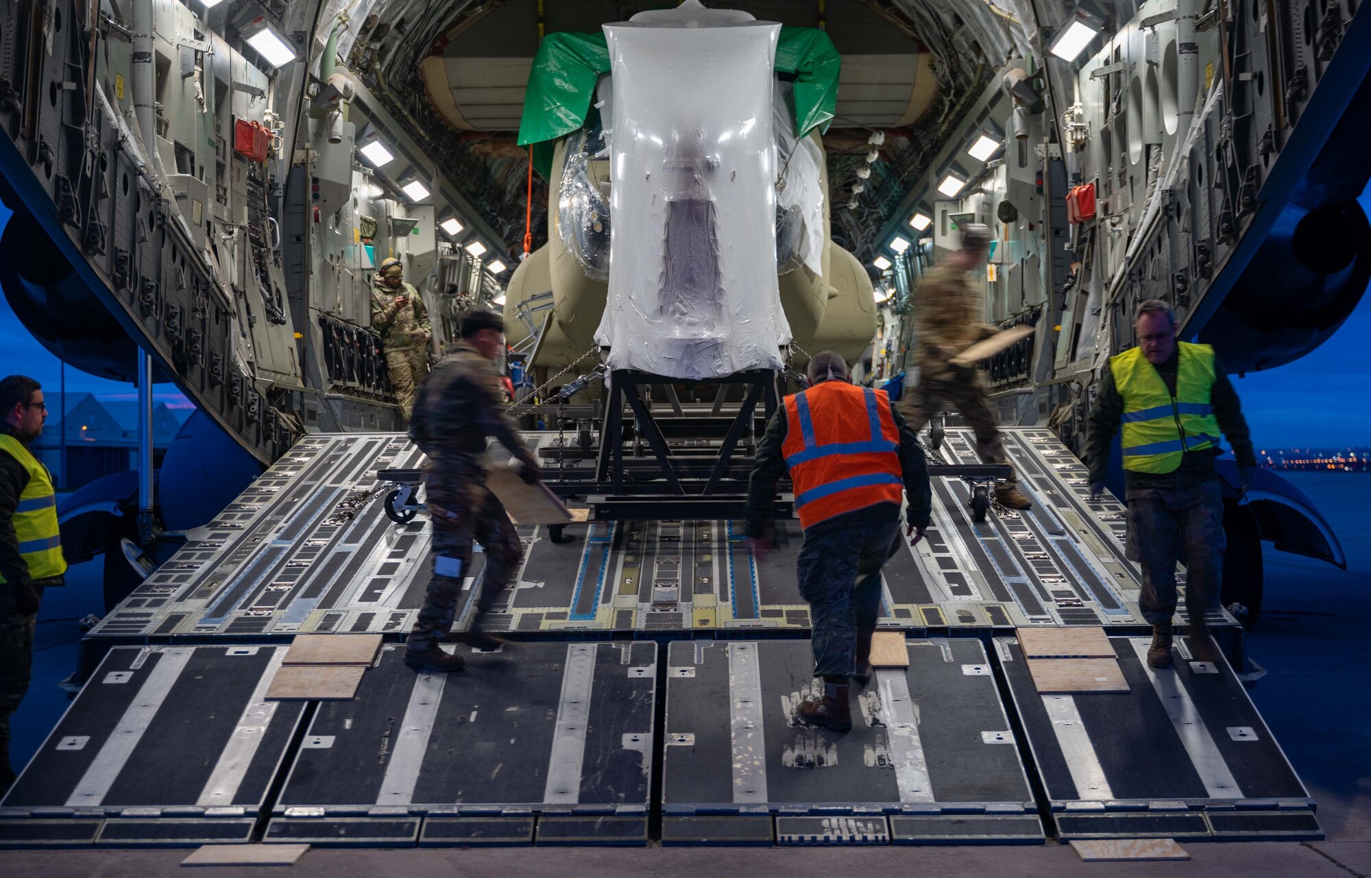 A CH-47F Chinook helicopter is unloaded from a C-17 Globemaster III assigned to Dover Air Force Base, Delaware, during a foreign military sales mission at Torrejón Air Base, Spain, Jan. 16, 2023. The United States and Spain recognize the central importance of the NATO alliance in ensuring transatlantic peace and security. As NATO allies for 40 years, the U.S. and Spain are steadfastly committed to providing NATO with ready forces and capabilities, strengthening transatlantic ties. (U.S. Air Force photo by Senior Airman Faith Barron)