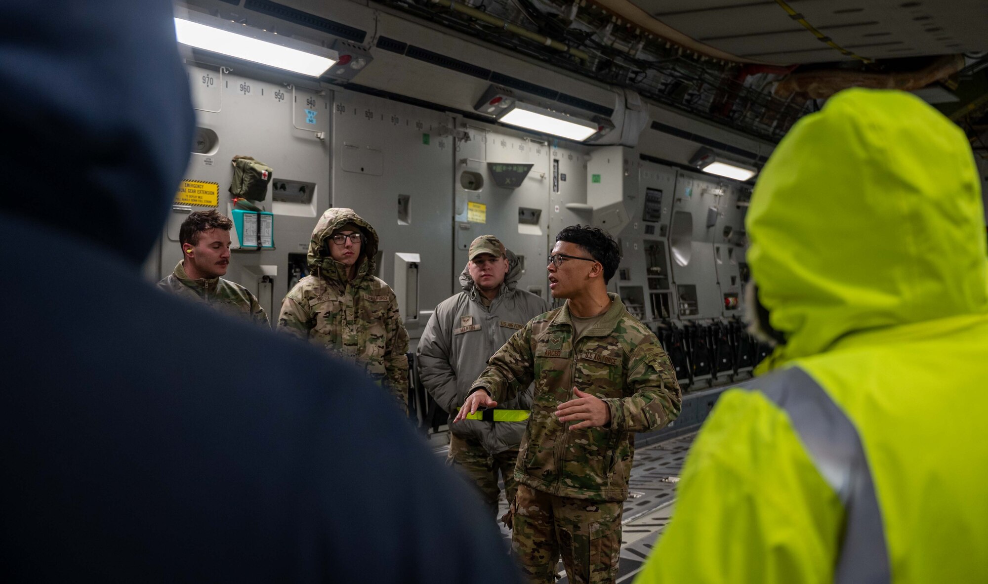 Senior Airman Frankie Arceo, 3rd Airlift Squadron loadmaster, gives a safety brief before loading cargo onto a C-17 Globemaster III during a foreign military sales mission at Dover Air Force Base, Delaware, Jan. 14, 2023. The C-17 transported a CH-47F Chinook helicopter to Torrejón Air Base, Spain as part of the Department of Defense’s FMS program. (U.S. Air Force photo by Senior Airman Faith Barron)
