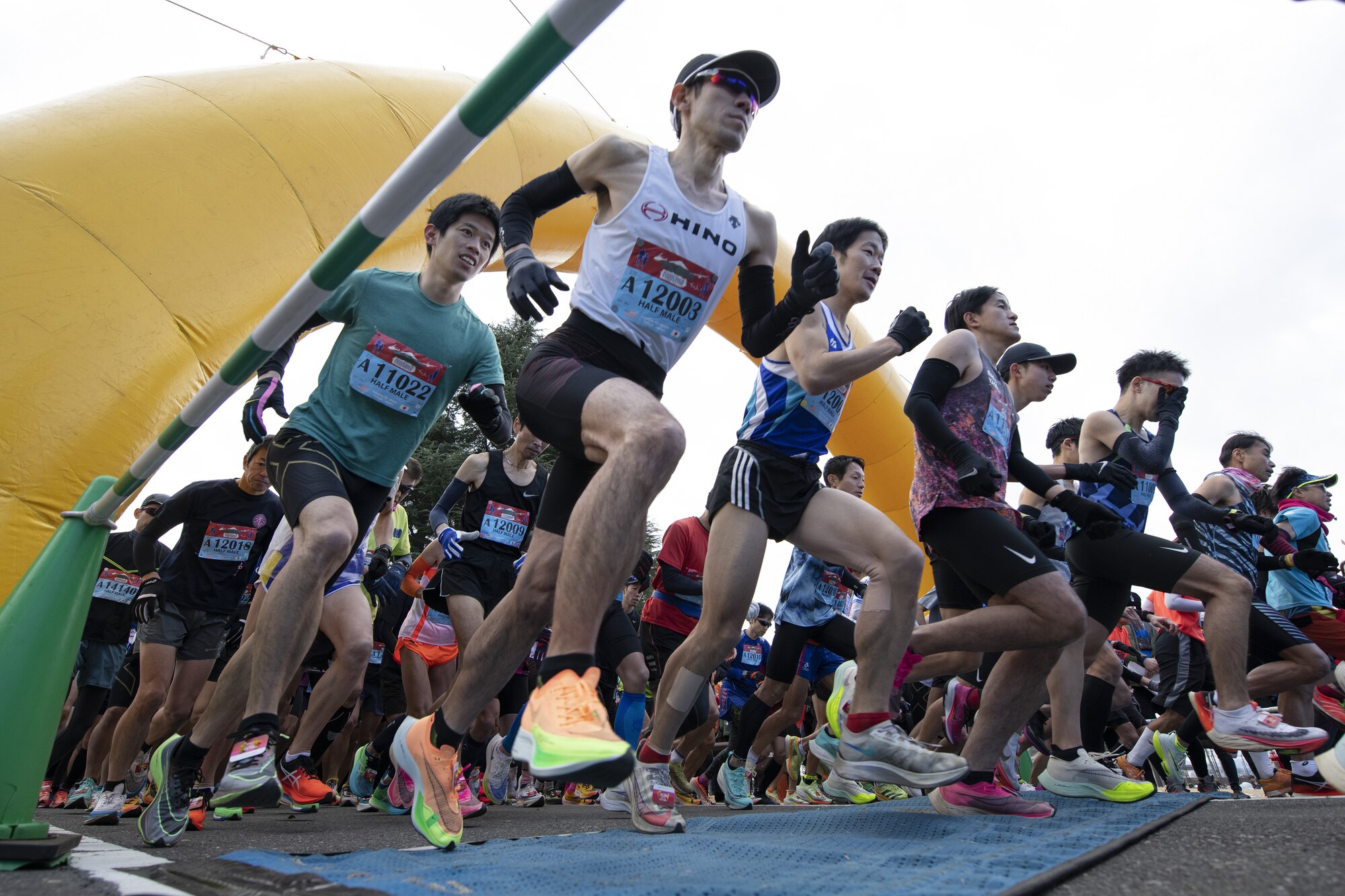 Half-marathon runners launch from the starting line during the 42nd annual Frostbite Road Race.