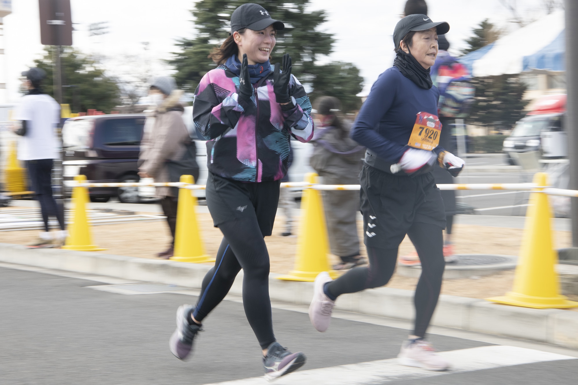 Runners participating in a 5-km run event speed towards the finish line during the 42nd annual Frostbite Road Race.